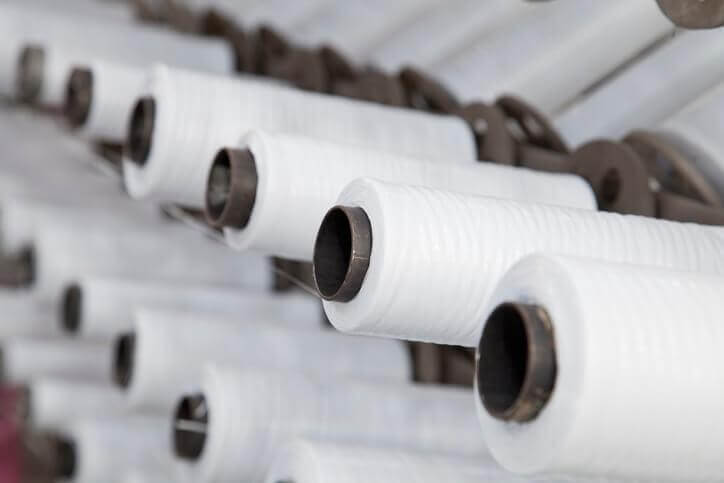 rolls of polypropylene plastic stored in a warehouse