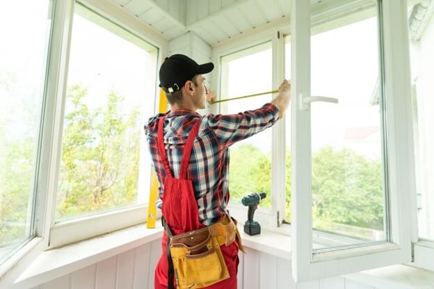 Man installing an acrylic noise barrier
